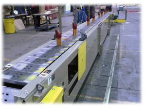 slat-conveyor-with-jigs-attached
